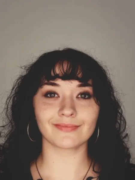 Person looks at camera and smiles